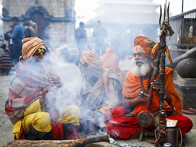 Vor dem Pashupati-Tempel in Kathmandu versammeln sich Sadhus - als heilig angesehene Männer -, um dort die ganze Nacht zu beten und zu meditieren.