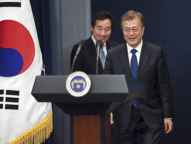 Südkoreas neu gewählter Präsident Moon Jae In (rechts) stellt den Nominierten für das Amt des Ministerpräsidenten vor, Lee Nak Yon (links hinter Moon).