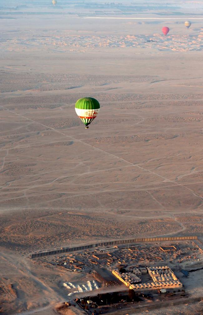 Ein Heissluftballon schwebt über Luxor.