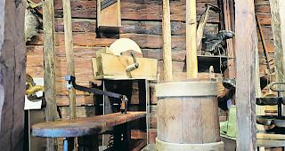 Alte Maschine. Vorne eine Laubs&auml;ge, hinten ein drehender Schleifstein. 